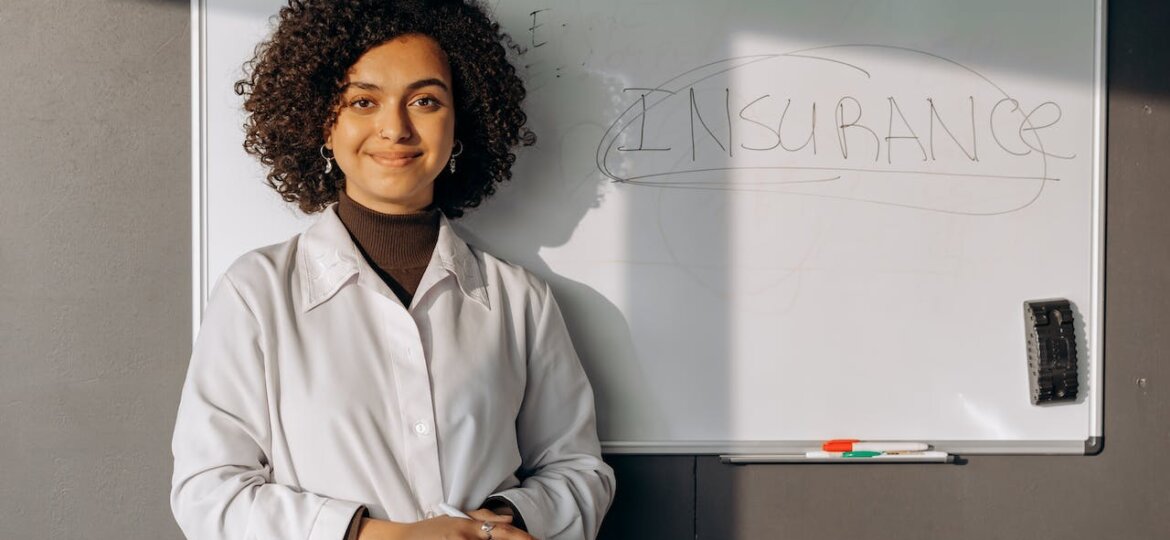 woman smiling with a whiteboard behind