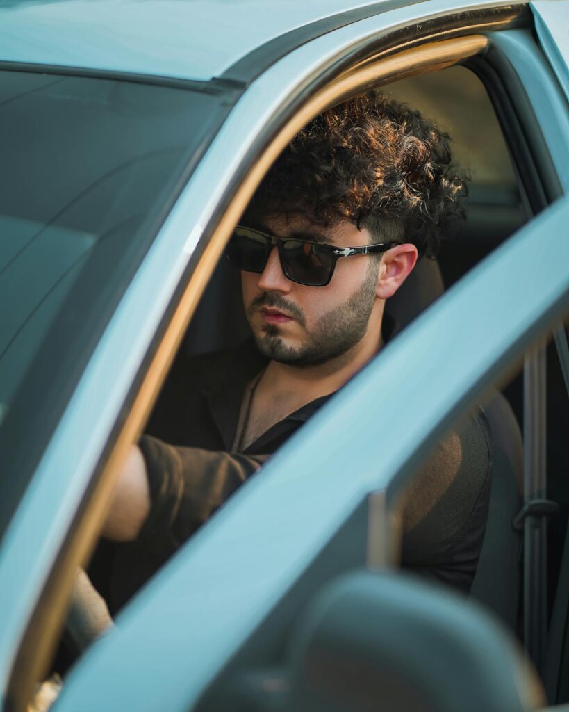 door open a man in a car with the door open